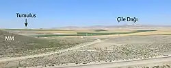 Rolling mountainous landscape with roads passing through, annotated with the two sites present