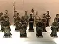Tomb figurines of a soldier and two men holding an axe and ji polearm, Ming dynasty