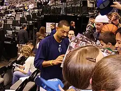 Howard is signing autographs in the court bleachers.