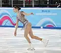 You Young begins the flip jump with her left foot on the inside edge and her right toe pick about to hit the ice