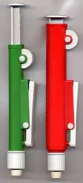 A manual propipetter adjusted by turning the wheel with the thumb