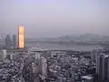 At sunrise, the 63 Building begins to glow.
