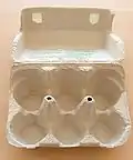 A pulp egg carton using a living hinge