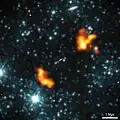 False-colour image showing Alcyoneus with LOFAR radio data at 144 MHz (orange) and WISE infrared data at 3.4 micron (blue) overlaid.