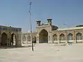 The mosque sahn, iwan, and minarets