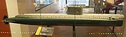 The world's first nuclear submarine, the USS Nautilus (SSN-571) of 1954, shows a very clean stern section, while the bow is clearly to some extent inspired by the Type XXI. Her test depth of 210 m was comparable to the German boat, but at 23 kn (43 km/h) submerged she was faster by far, even faster than any previous US fleet boat had been on the surface. Unfortunately, serious design flaws in her bow and sail resulted in extreme vibrations at high speed, and worsened over time. At the end of her life 4 kn (7 km/h) was enough to deafen her sonar, and the noise drastically increased the risk of detection.