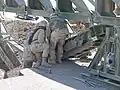 Soldiers (299 MRBC USAR [1]) attach the link reinforcement set to the underside of the bottom panel