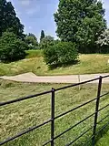 Surviving easterly ditch of the 14th-century castle in 2023