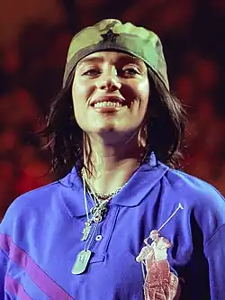 Eilish smiling while looking at a camera