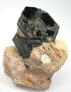 Image 12Perfect basal cleavage as seen in biotite (black), and good cleavage seen in the matrix (pink orthoclase). (from Mineral)