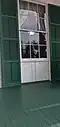 A close up of the windows of the Bronson–Mulholland House. Most of the windows are jib windows; note the doors below the glass that could be opened to fully extended the window to the floor.