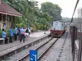 Train driver dropping a key token for the northern section between Woodlands and Bukit Timah.
