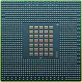 The underside of the 90 nm Cell/B.E. processor showing its 1242 solder balls, each 0.6 mm in diameter, and its array of 35 capacitors