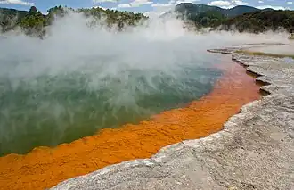 The orange colour originates from deposits of arsenic and antimony sulfides.