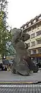 A monument of a pregnant woman made of mirrors