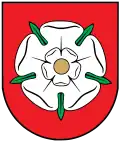 A coat of arms depicting orange tools on a white background on the top and an orange sun on a dark green background on the bottom