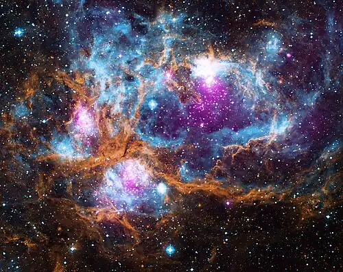 Image 4 NGC 6357 Photograph credit: NASA NGC 6357 is a diffuse nebula in the constellation Scorpius. This composite image of the nebula contains X-ray data from the Chandra X-ray Observatory and the ROSAT telescope (purple), infrared data from the Spitzer Space Telescope (orange), and optical data from the SuperCosmos Sky Survey (blue). Radiation from hot, young stars is energizing the cooler gas in the clouds that surround them. Often known as the Lobster Nebula, the astronomical object has also been termed the Madokami Nebula by fans of the anime Madoka Magica due to its supposed resemblance to the main character. Scientists at the Midcourse Space Experiment prefer the name War and Peace Nebula, because the bright, western part resembles a dove, while the eastern part looks like a skull in infrared images. More selected pictures