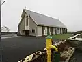 Our Lady Of Lourdes Church in Cross with the Village Pump