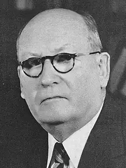 Man in a suit facing forward towards camera.
