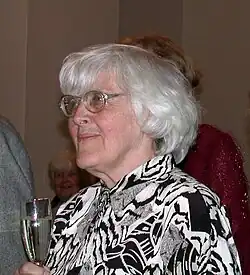 Scientist Linda Poots holds a glass of champagne