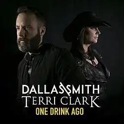 A bearded man facing left and a woman in a black cowboy hat facing right, both in profile, against a black background