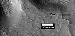 These ridges may be dikes or joints formed as a consequence of a crater impact. As seen by HiRISE under the HiWish program.