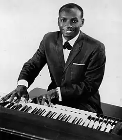 A man playing an electric organ