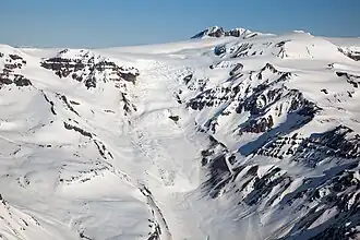 Snow-covered mountain slope with rock exposers