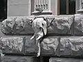 The building features various carvings, such as this elephant-head gargoyle