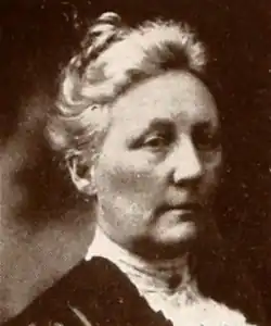 An older white woman with white hair in an updo