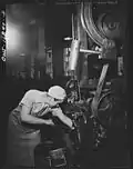Emma Dougherty who does a man's work for a man's pay, cleaning out her end-grinding machine