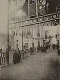 Photograph of a street entrance in Cairo by Delort Gléon from 1889, showing the use of khayamiya as a street ornament