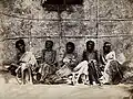 Famine in Mysore, India; six emaciated women, five sitting a Wellcome