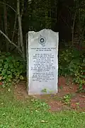 A monument at Father Rale's grave memorializing his work.