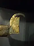 The tail with the remains of the inscription