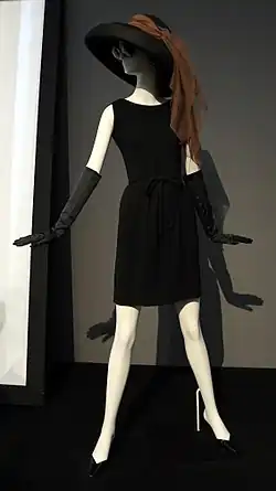 Black minidress with black wide-brimmed hat