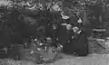 'In a Haven of Peace' (Illustrated London News): Nuns and village children at the grave of Redmond at Locre in June 1917