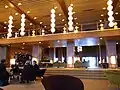 Hotel lobby with modernist design featuring geometric patterns and warm lighting