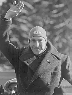 Ivar Ballangrud wearing a coat in front of pine trees