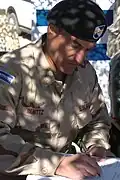 A photograph of Salvadoran colonel José Atilio Benítez Parada in military camouflage uniform