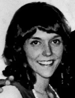 Black-and-white picture of a brunette woman smiling.