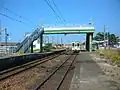 View of platform with approaching 100 series train