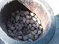 Korarima fruits are placed in a vessel for grinding.