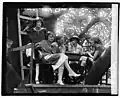 Cleon Throckmorton (middle), Kathryn Mullin (far right), Inez Hogan (top left) and others in the tree house cafe. The flappers wear the rolled stockings and low heels typical of the era's fashion.[56]