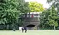 Piccadilly Line train (1973 Stock) visible from Lampton park