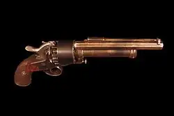 top view showing the ramming rod parallel to the barrel and the lever of the pivoting striker