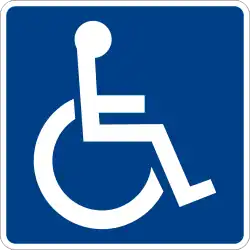 White line figure of a person seated over the axis of a wheel on blue background