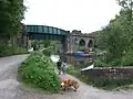 The canal swings away and passes under the railway viaduct