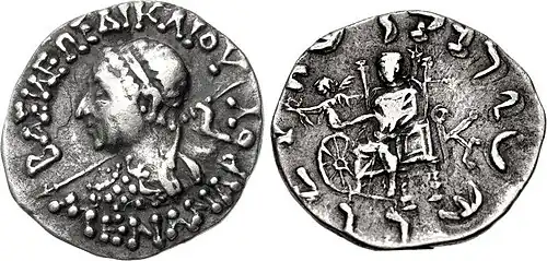 Silver Drachm of Menander II (95–80 BCE) with Zeus and Nike handing a victory wreath to a Wheel of the Law[13]