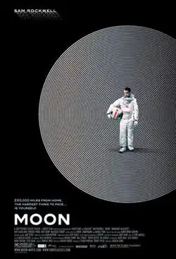 Standing alone, an astronaut holds his helmet in his hand.